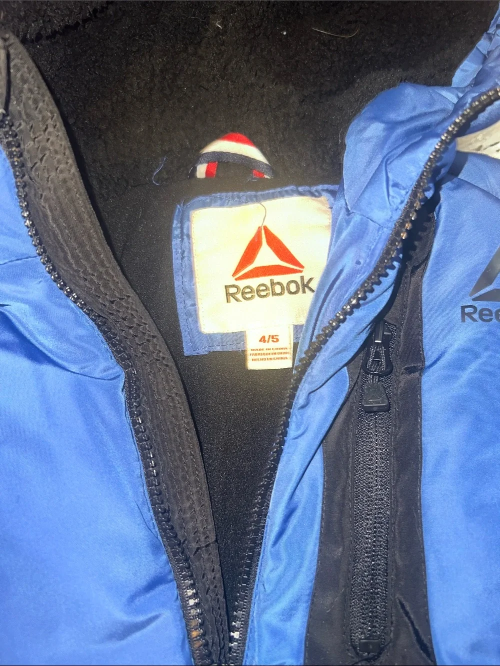 This is a blue Reebok toddler puffer jacket featuring a cozy hooded design 4/5